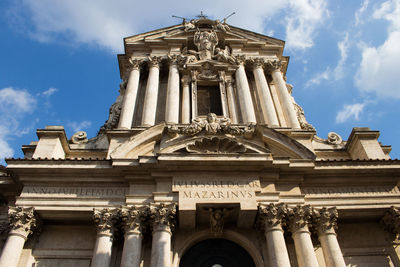 Low angle view of historical building against cloudy sky