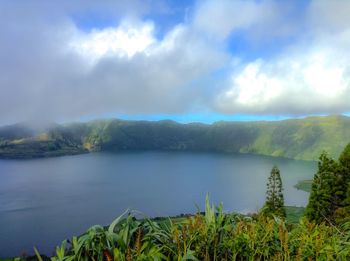 Scenic view of lake and mountains against sky