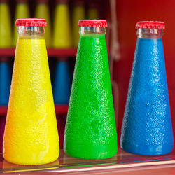 Close-up of multi colored bottles on table