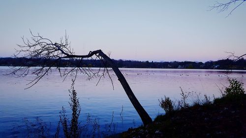 Scenic view of lake against sky at sunset