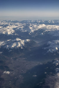 Aerial view of snowcapped mountains against sky