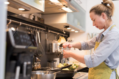 Side view of woman having food