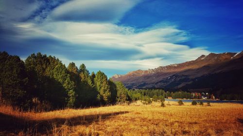 Scenic view of mountains against cloudy sky