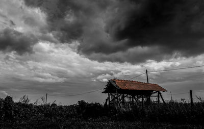 Traditional windmill on field against sky