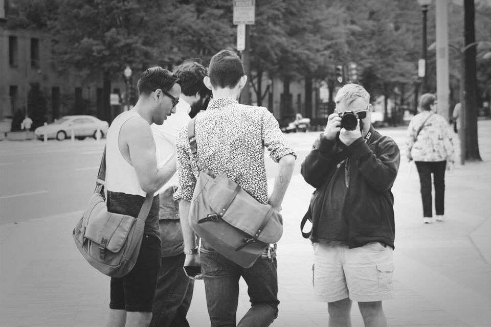 lifestyles, men, street, walking, rear view, person, leisure activity, casual clothing, city, city life, full length, large group of people, togetherness, standing, incidental people, focus on foreground, road, building exterior