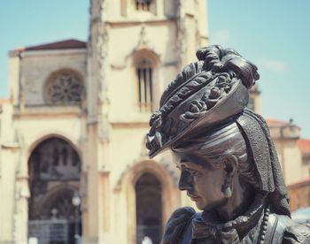 Statue of buddha against building