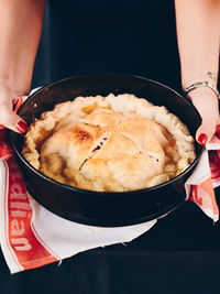 Close-up of person holding a freshly baked pie