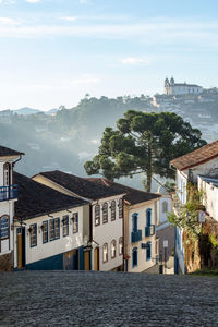 Buildings by sea against sky in city