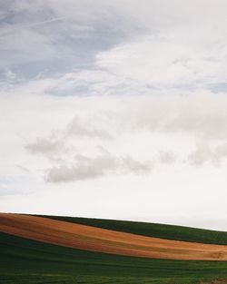 Scenic view of landscape against cloudy sky