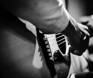 Close-up of man playing guitar