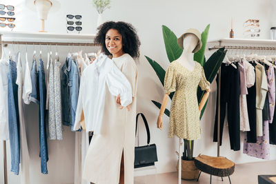 Smiling woman shopping at clothing store