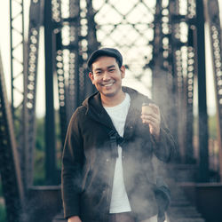 Portrait of smiling young man standing outdoors