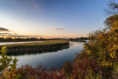 Scenic view of lake against sky during sunset