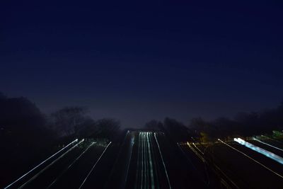 High angle view of light trails on highway at night