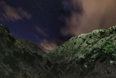 Low angle view of mountain against sky at night