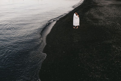 High angle view of woman standing on beach