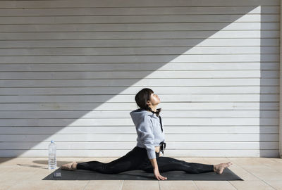 Chinese young woman doing yoga exercise in the sun
