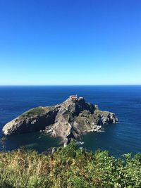 Scenic view of sea against clear blue sky