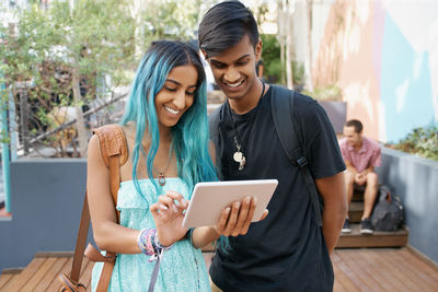 Smiling couple looking at digital tablet