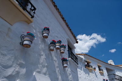 Low angle view of decorations hanging on building against sky