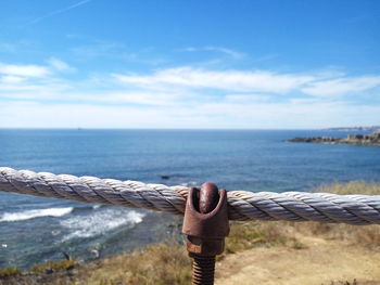 Full length of a young woman overlooking calm blue sea