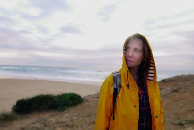 Portrait of young woman standing on beach