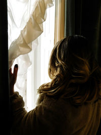 Close-up of young woman looking at home
