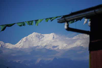 Low angle view of snowcapped mountains against sky