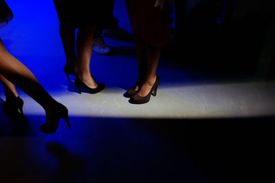 Low section of man and woman at night