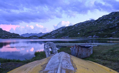 Scenic view of lake by mountains against sky