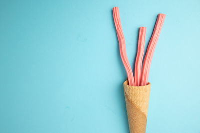 High angle view of multi colored candies against blue background