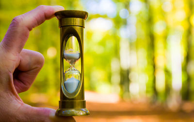 Close-up of person holding hourglass