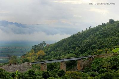 Scenic view of mountains against cloudy sky
