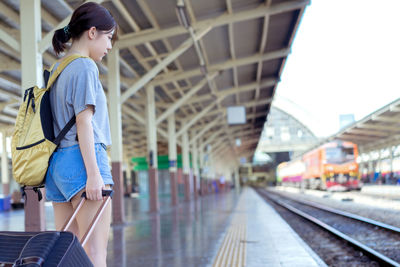 Side view of woman at railroad station