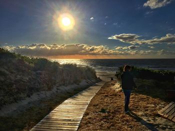 Scenic view of beach against sky during sunset