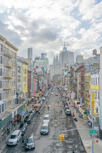 High angle view of city street in china town, new york. buildings, cars and traffic lights,