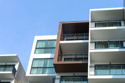 Low angle view of buildings against clear blue sky