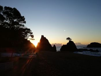 Scenic view of sea against clear sky during sunset