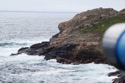 Scenic view of rocks in sea against sky