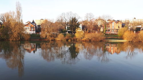 Reflection of trees and buildings on lake