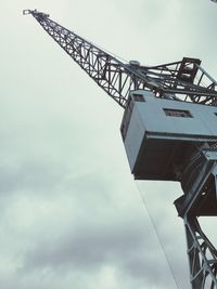 Low angle view of crane against sky