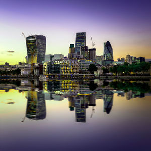 Reflection of buildings in lake against sky