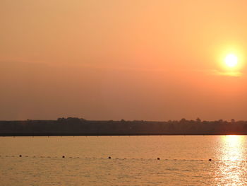 Scenic view of sea against orange sky