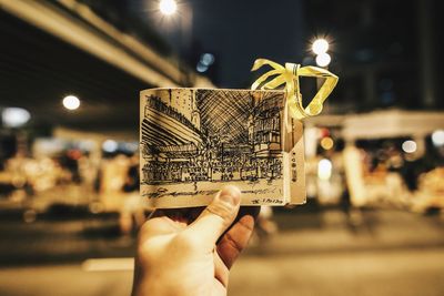 Cropped image of hand holding illuminated light