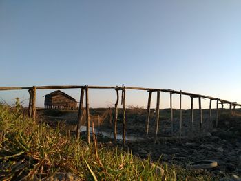 Abandoned built structure on field against clear sky