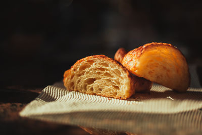 Close-up of croissant cut in half on table