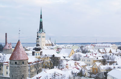 Snow covered city against sky