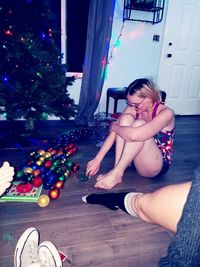 Young woman sitting on floor