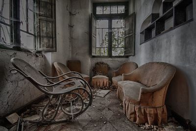 Old furniture in messy abandoned building