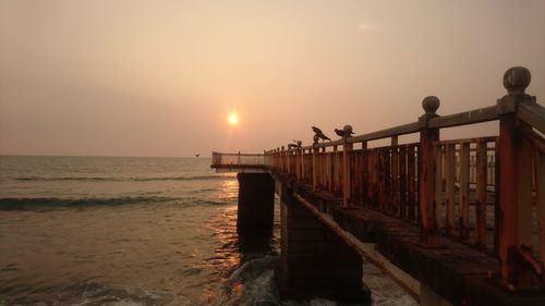 Scenic view of sea against clear sky during sunset